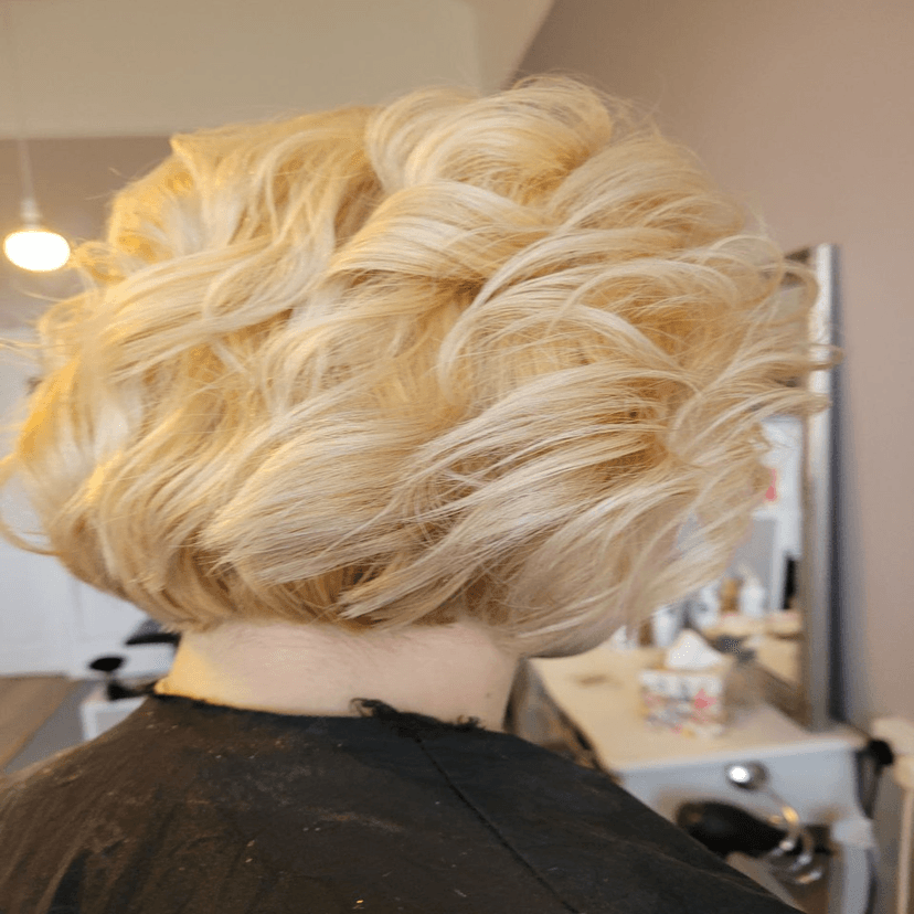 curly platinum blonde bob back view