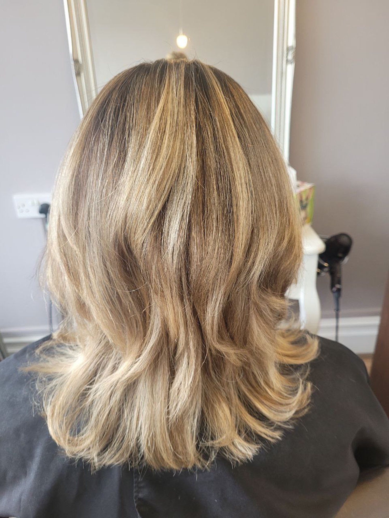 mid blonde hair styled and curled