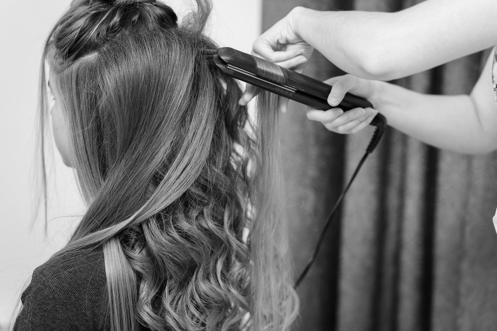 hair being styled with curling tongs